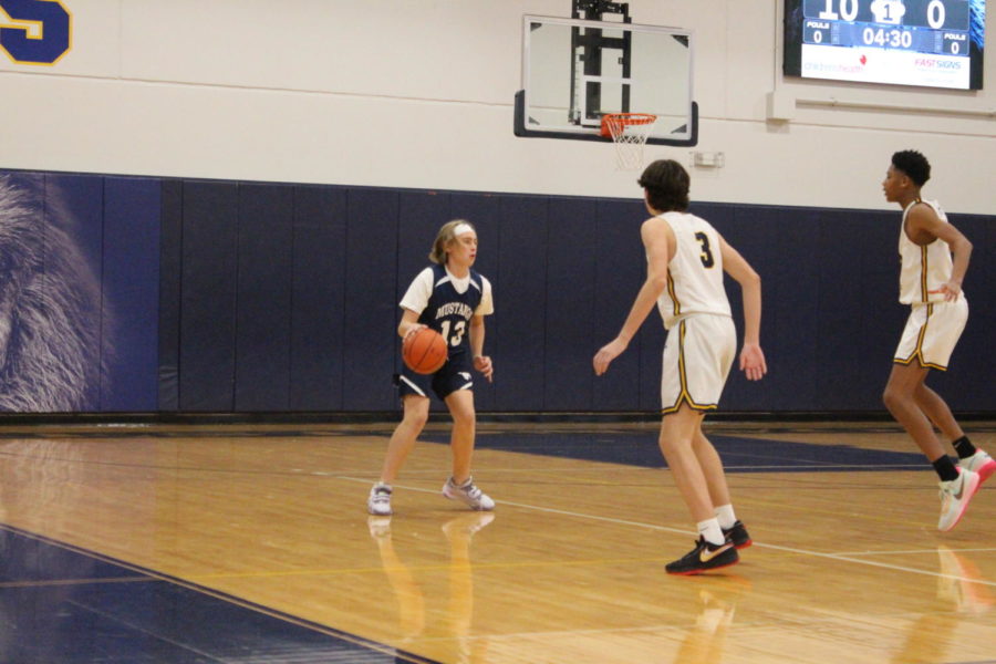 Seventh grader Wheeler Clayton takes the ball up the court.