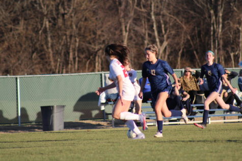 Sophomore Casey Gerardis dribbles the ball past the defender.