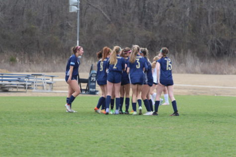 The Lady Mustangs celebrate after Senior Kate Nordhaus scores the first goal of the game.