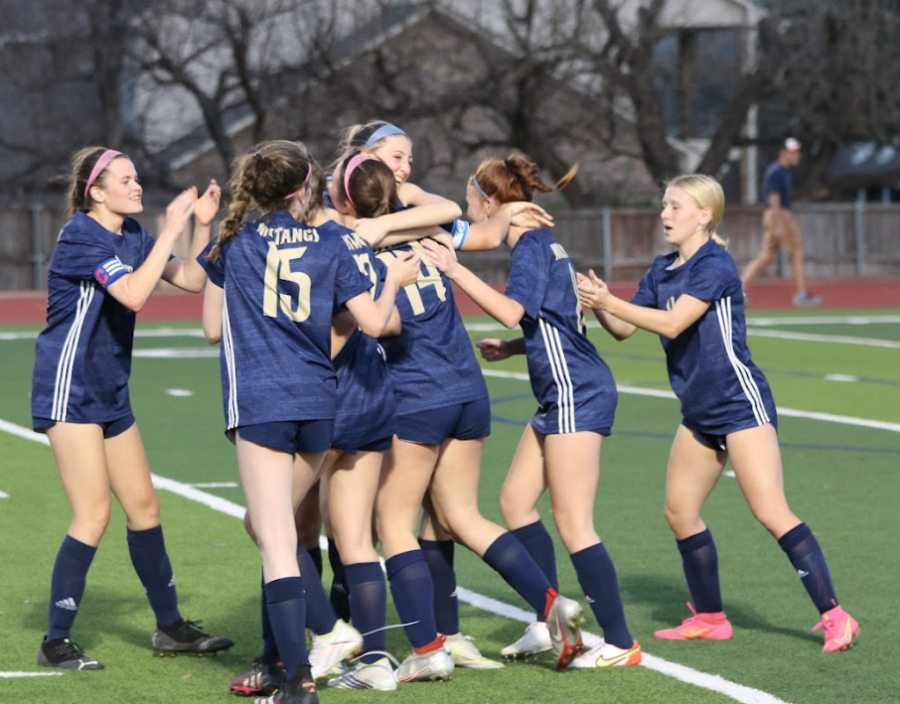 Lady Mustangs celebrate after scoring a goal. 
