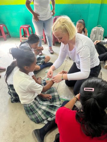 Senior Lily Jornod giving a bracelet to a kid in Guatemala. 