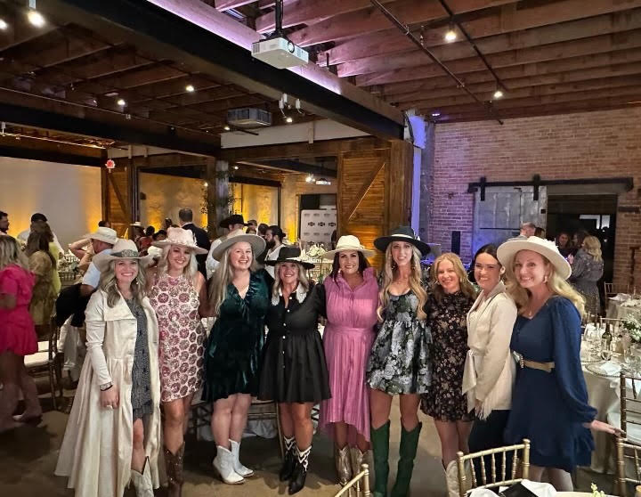 MCA Moms pose for a photo at the Boots and Pearls Auction.