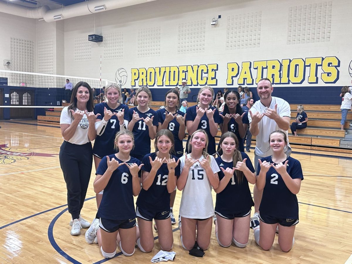 The Middle School D1 volleyball team poses for a picture after their win against Providence.