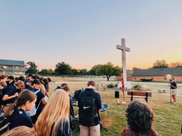 Students gather around the cross.
