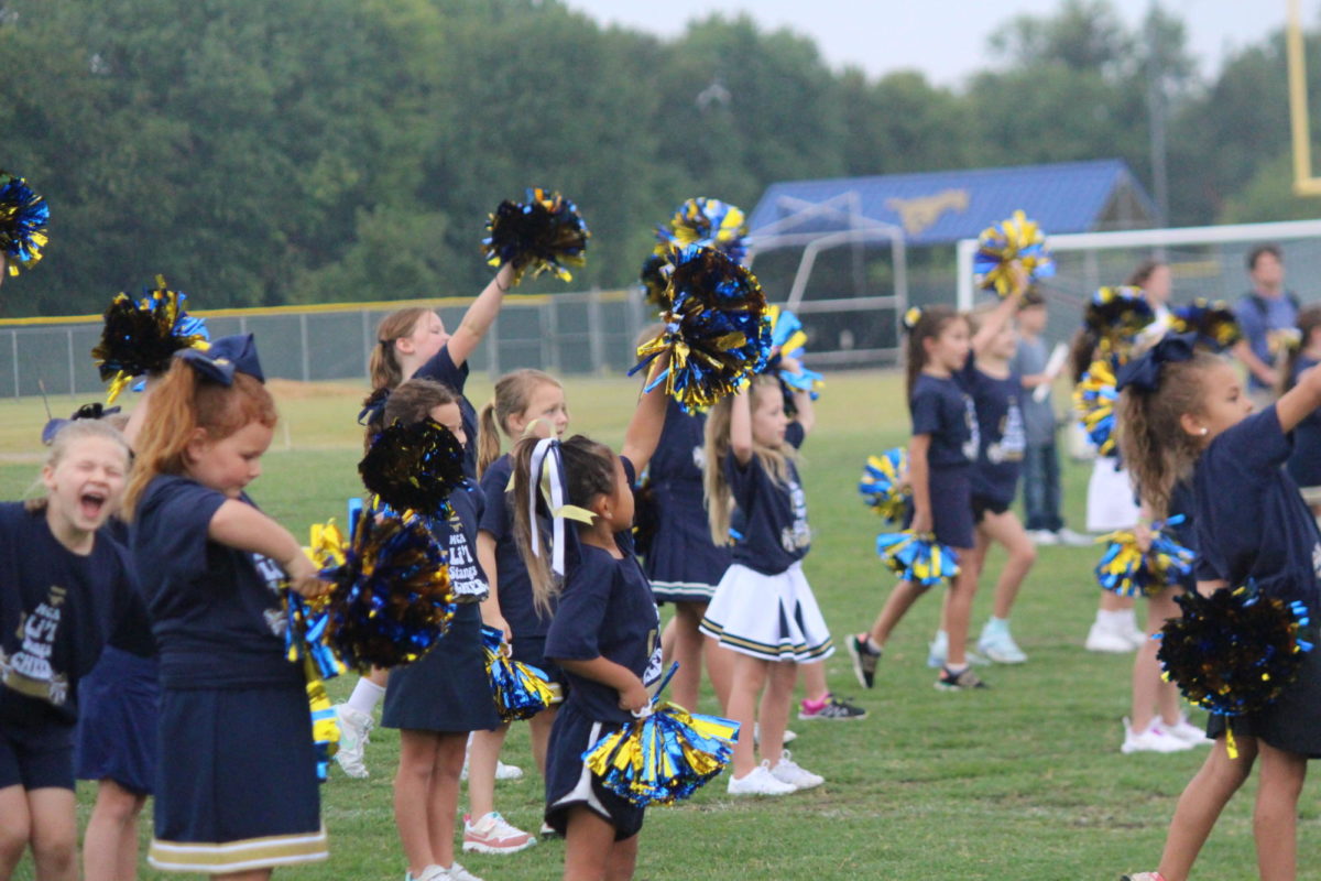 Lil stangs cheerleaders perform at the Homecoming tailgate. 