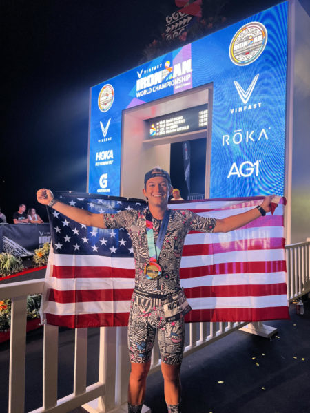 Nick Catullo poses with the American flag after finishing the race.