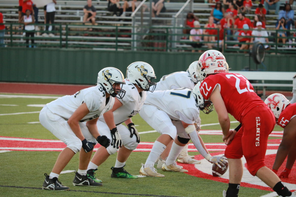 The Mustang offensive line gets ready for the defense.