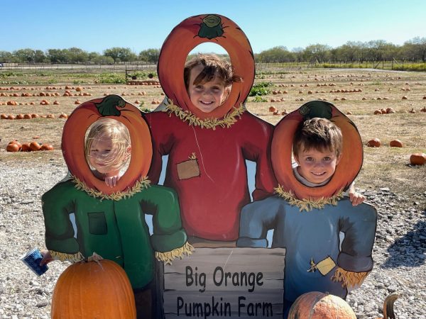 Kindergarteners Jonah Davis, Tyler McRobert, and Caspian Bone pose for a picture in the pumpkins.