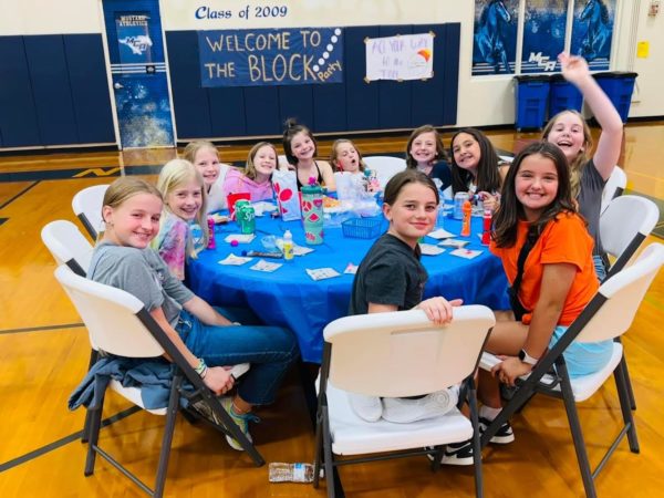Lower School Students smile for a picture while playing bingo. 
