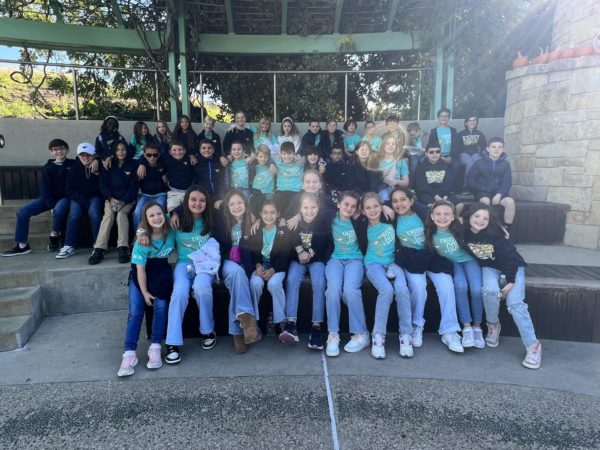 The fifth grade class smiles for a picture during their field trip.