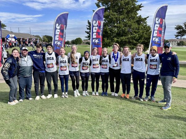 The cross country team poses for a picture after state.