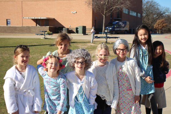 Lower School girls take a picture in their 100 day outfits.