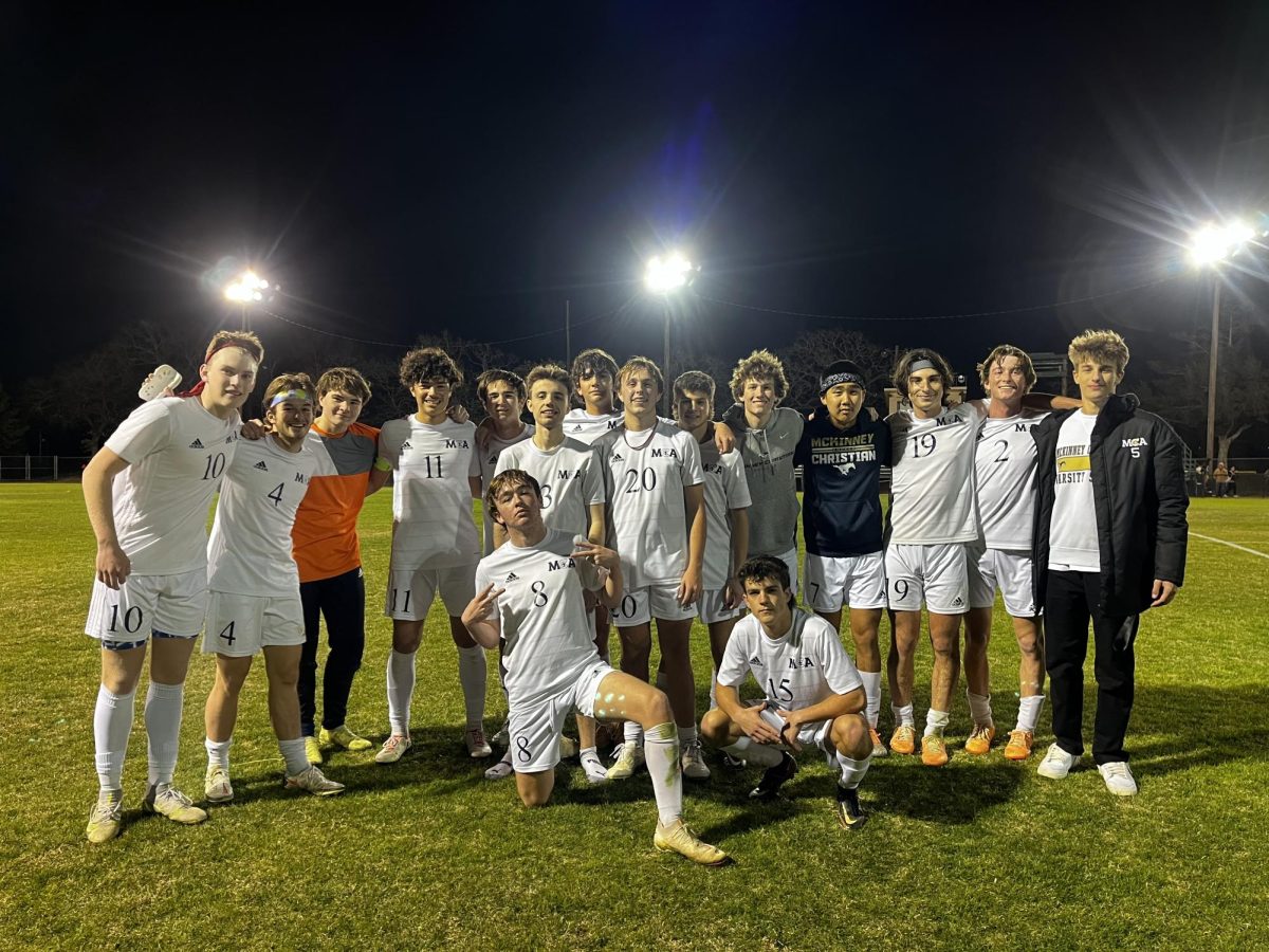 The Upper School boys soccer team pose for a picture following their win. 