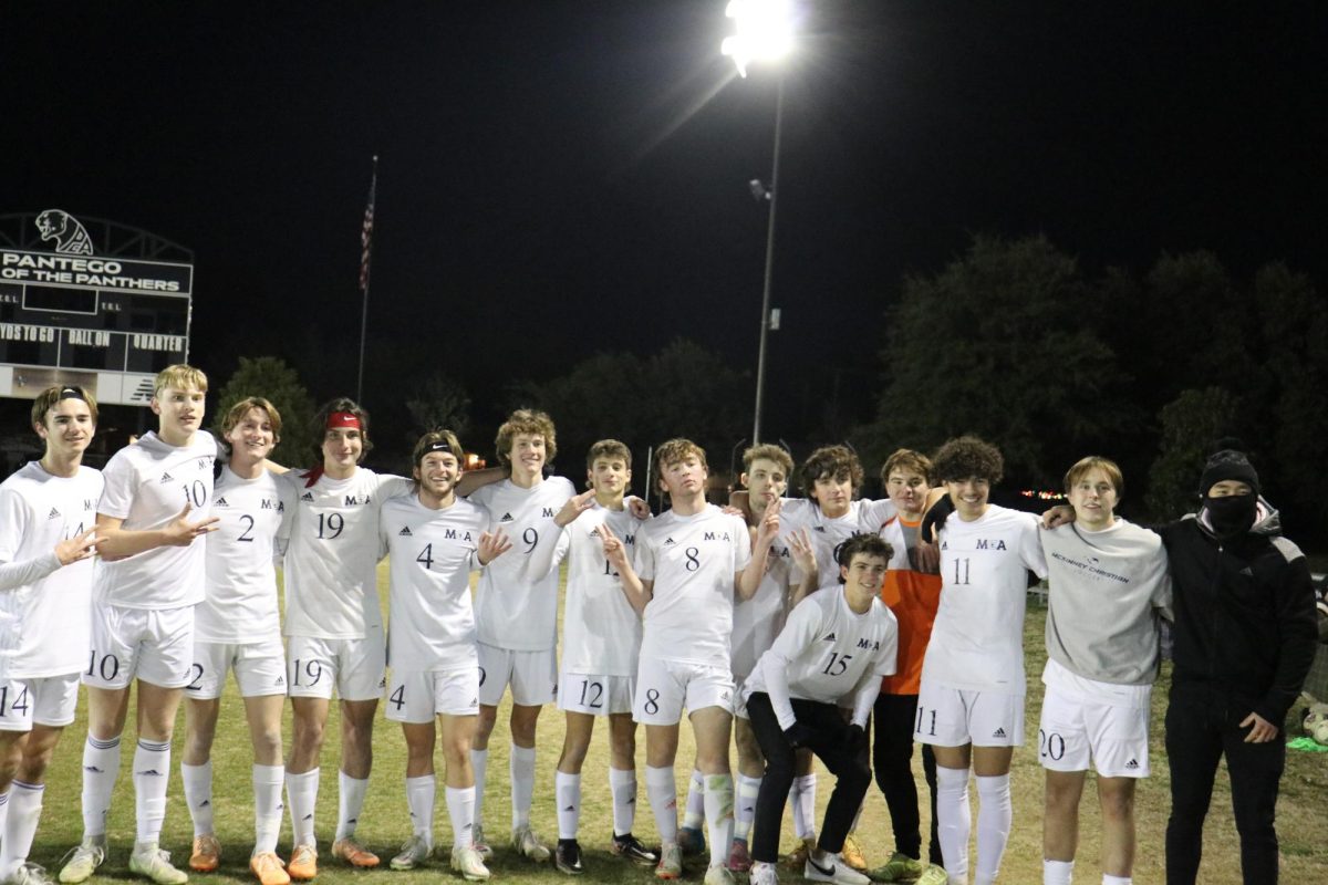 Varsity boys pose for a picture after the game.
