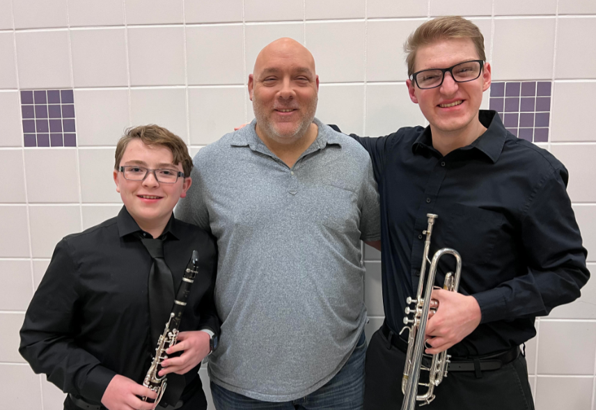 Silas Urban (7), Director Ken Snow, and Jackson Iseneker (12) taking a photo after the All Region band concert