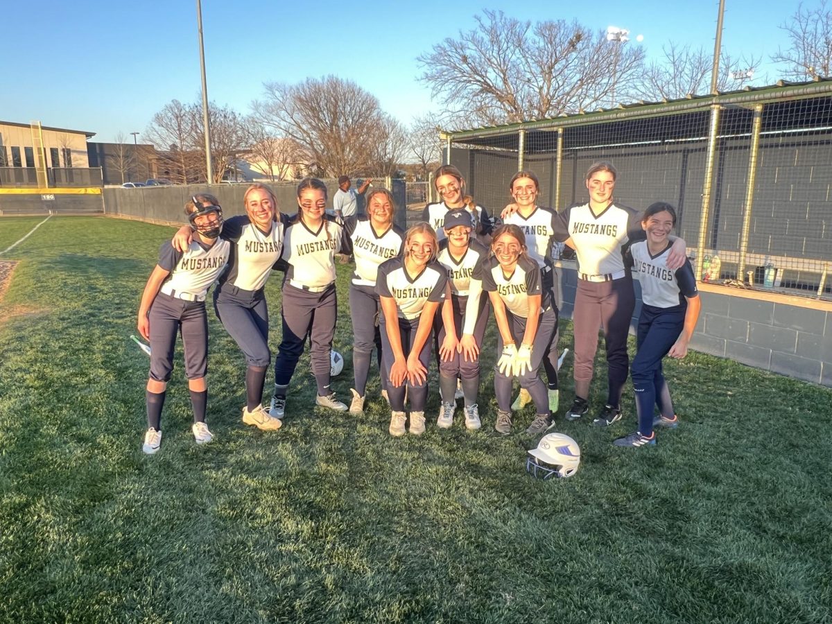 The McKinney Christian Middle School softball team smiles for a picture after their win.