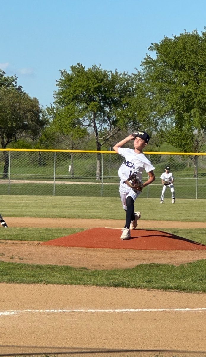 Sixth grader Grayson Remy throws a pitch.
