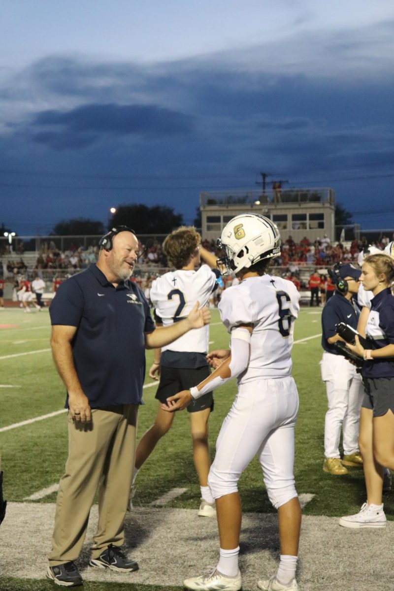 Sophomore Luke Dreffs receivesi words of encouragement by Head Coach Dan Whitsett.  