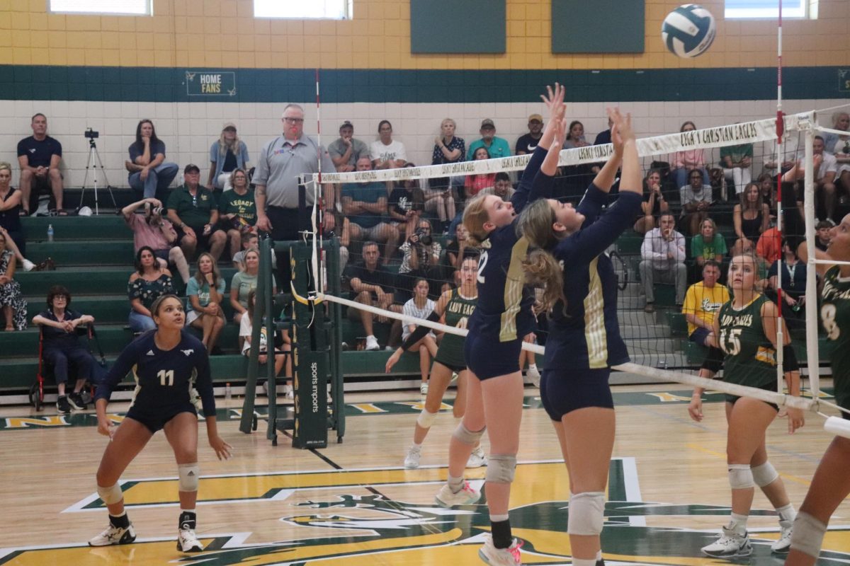 Senior Brooklyn Claudio and junior Aubrey Hejl go up for the block. 