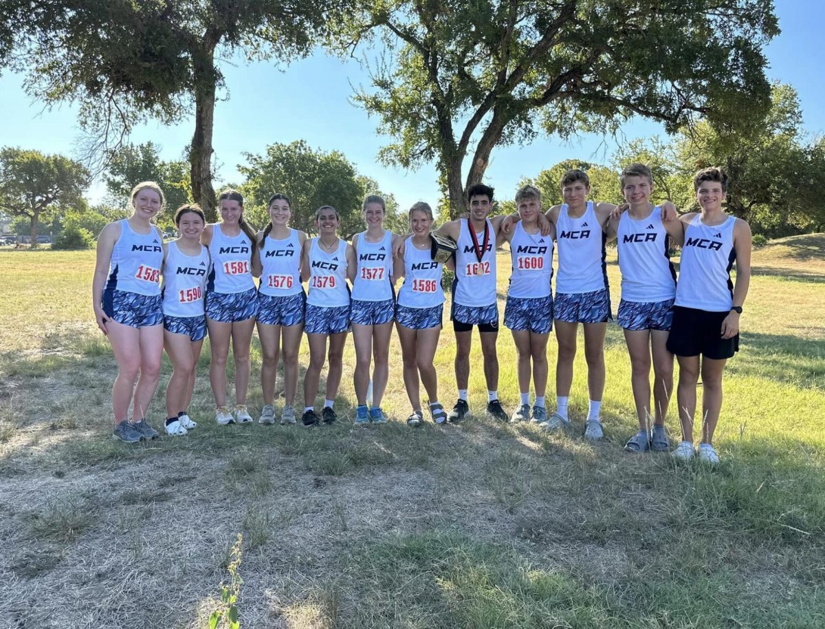 Varsity cross country team poses for a team picture. 