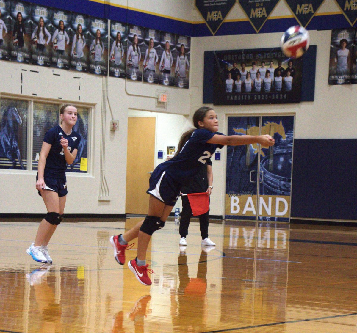 Sixth grader Mikaela Hunt passes the ball, while Emmerson Follis cheers her on.