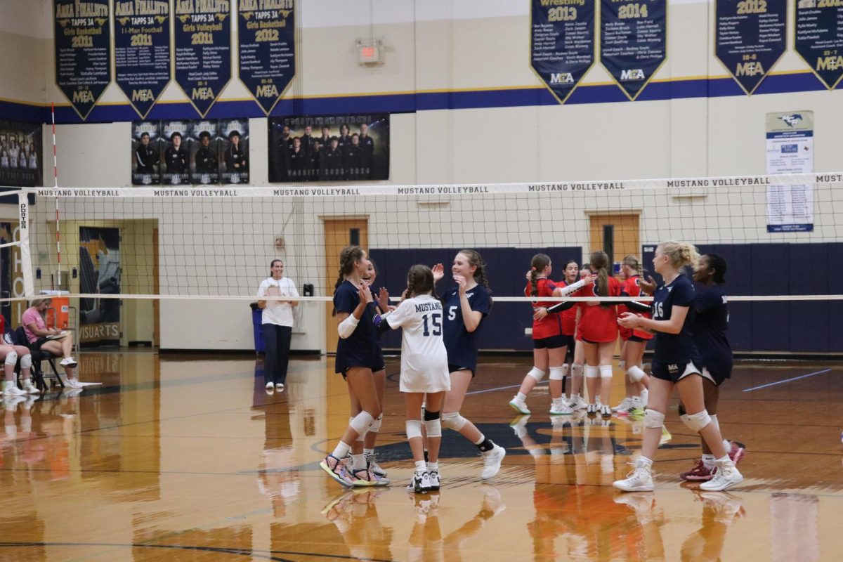 The team celebrates after winning the point.