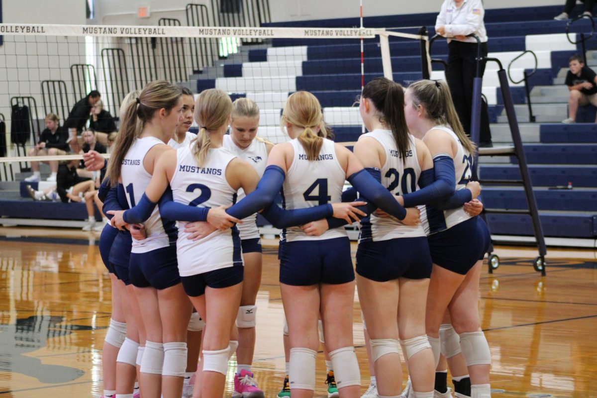 Junior Varsity huddles together to pray before the game.