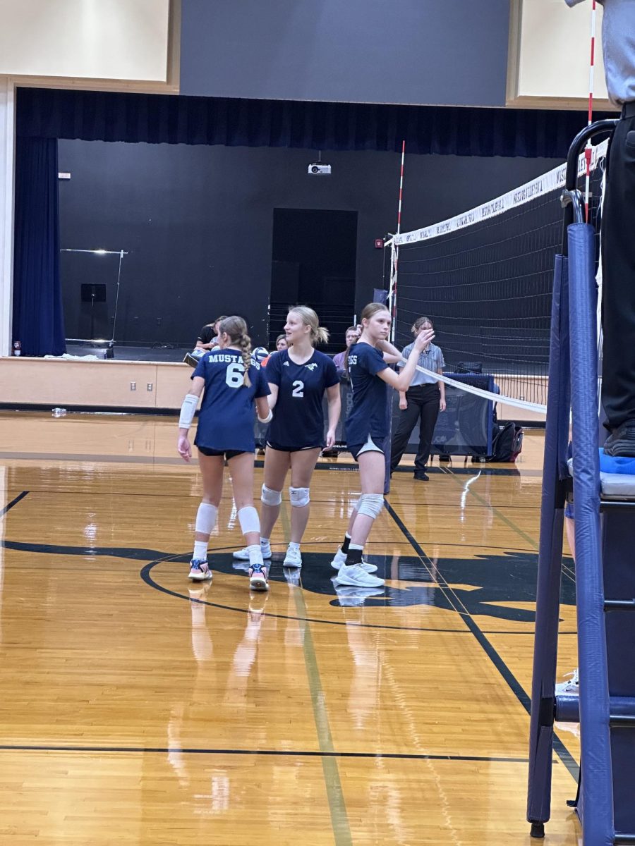 Eighth graders Kate Thomas, Marlee DePetris and Sara Webb wait for the serve.