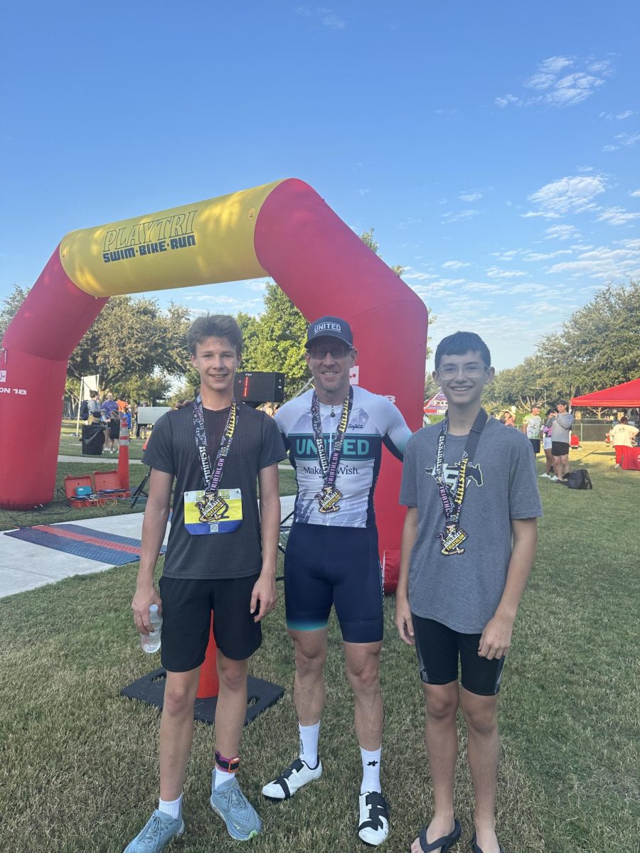 Eighth Graders Camden Holley and Quaid Morrow take a picture with Head Coach Rhett McKeller after their races. 