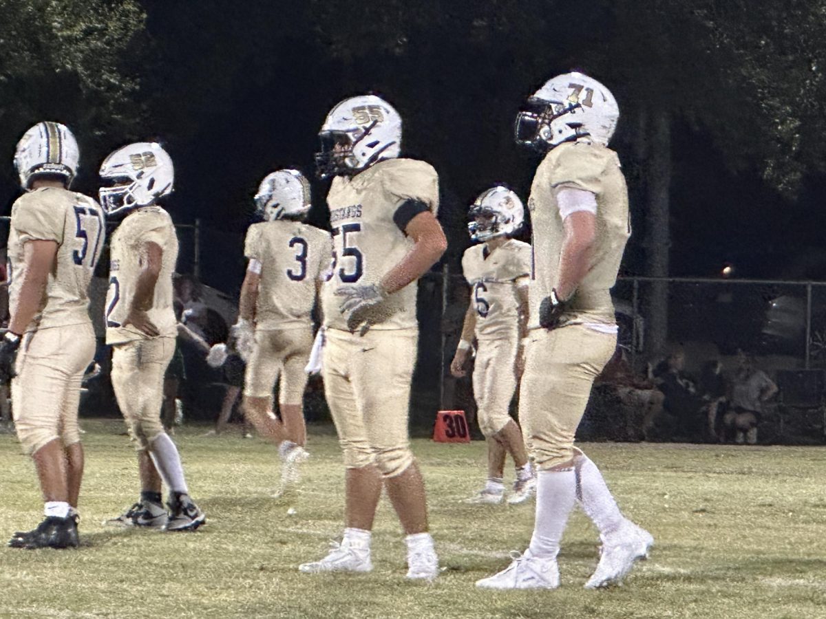 The Mustang offensive linemen stand ready for the next play. 