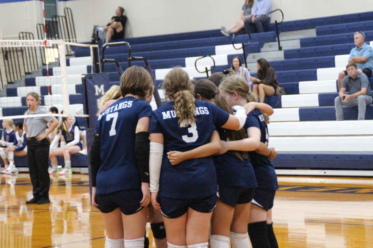 The D2 team huddles together after they get the point. 