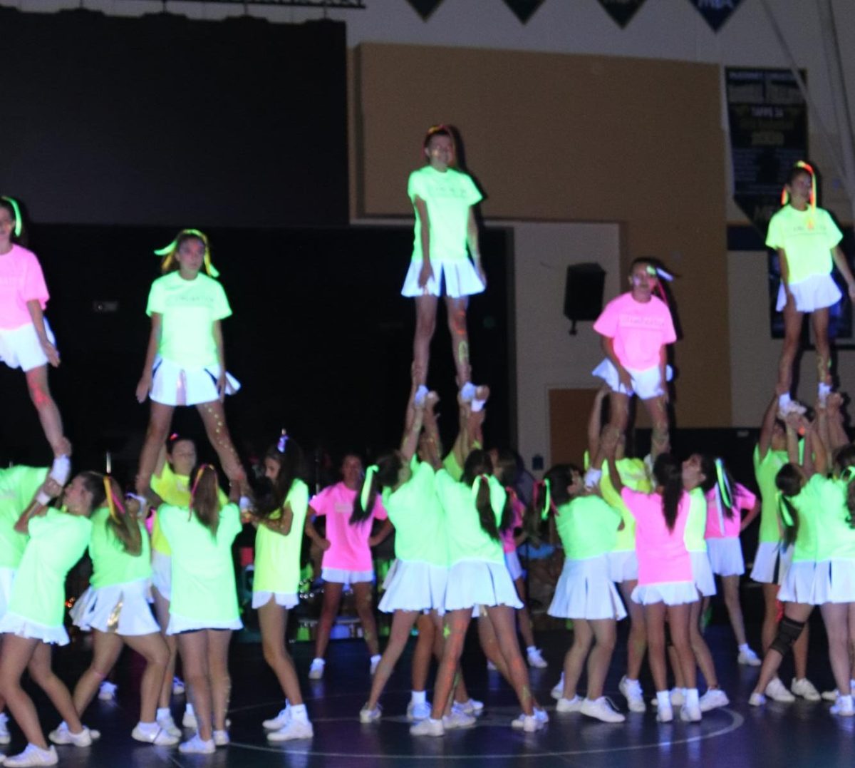 Cheer squad performs stunts.