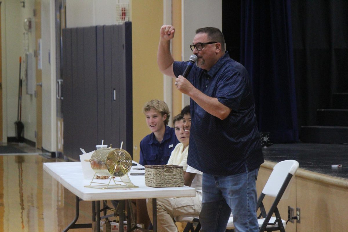 Chris Hydock reads off a number and letter for the families to mark off on their Bingo boards. 