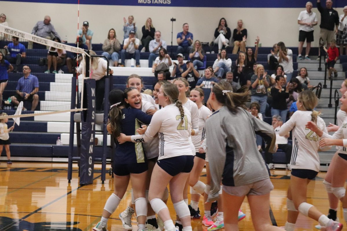 The Lady Mustangs celebrate after winning to Dallas Christian to claim the district title.