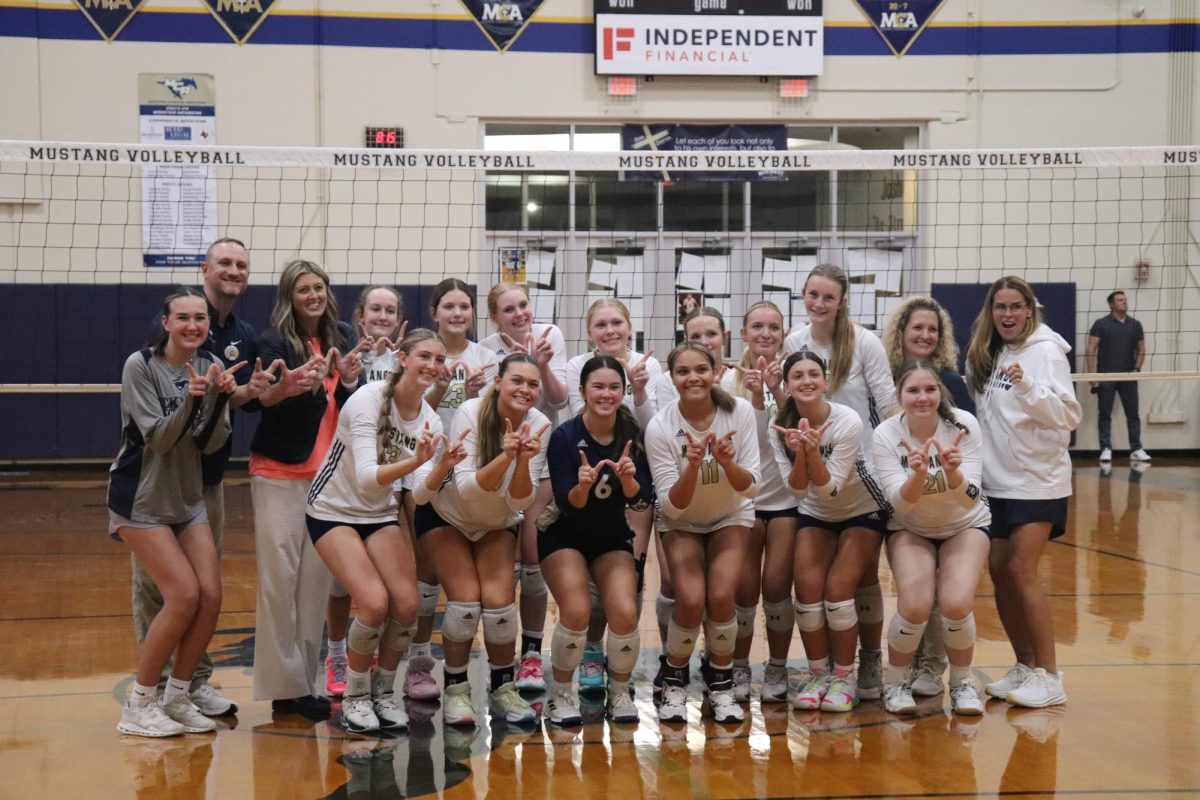 Varsity takes a picture together after winning districts.