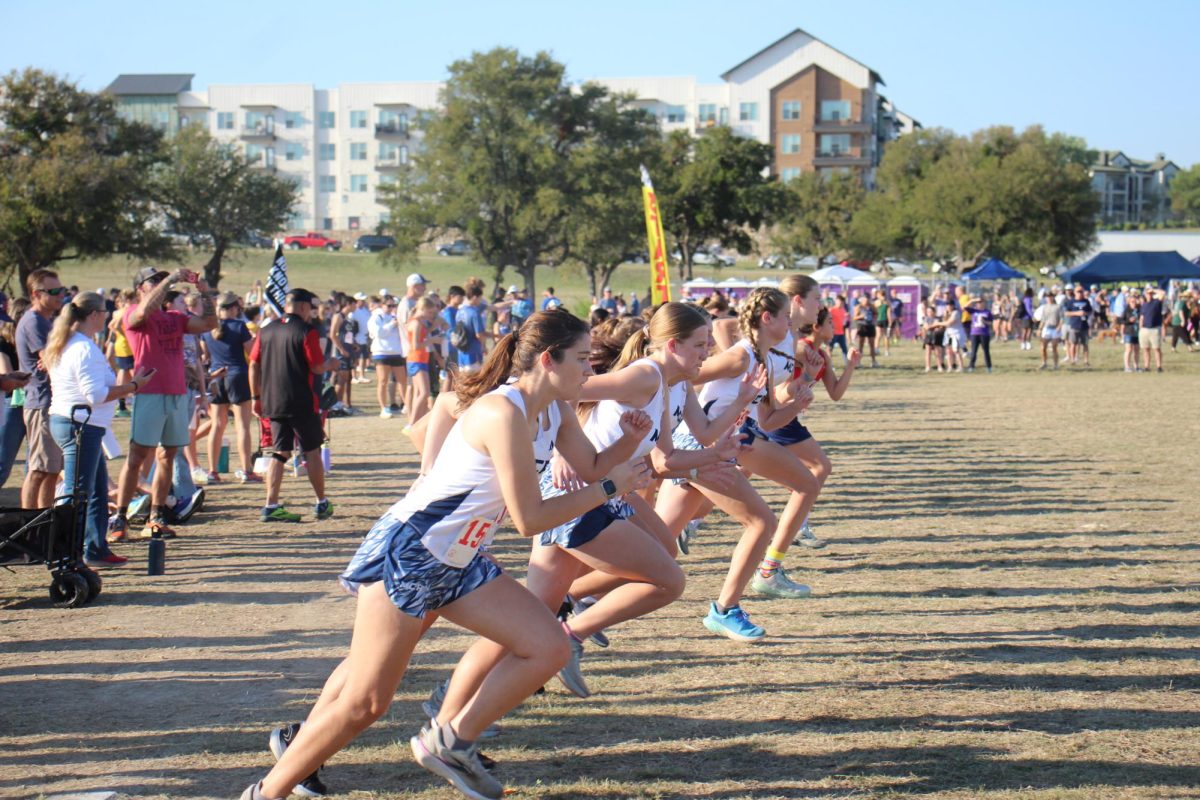 The cross country team takes off from the starting line. 