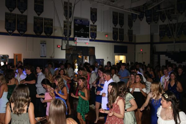 The student body dances along to the song "Footloose" by Kenny Loggins. 