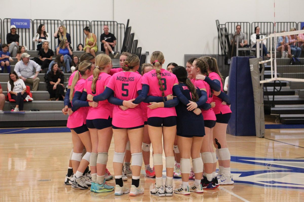 The Lady Mustangs get together before the game starts.