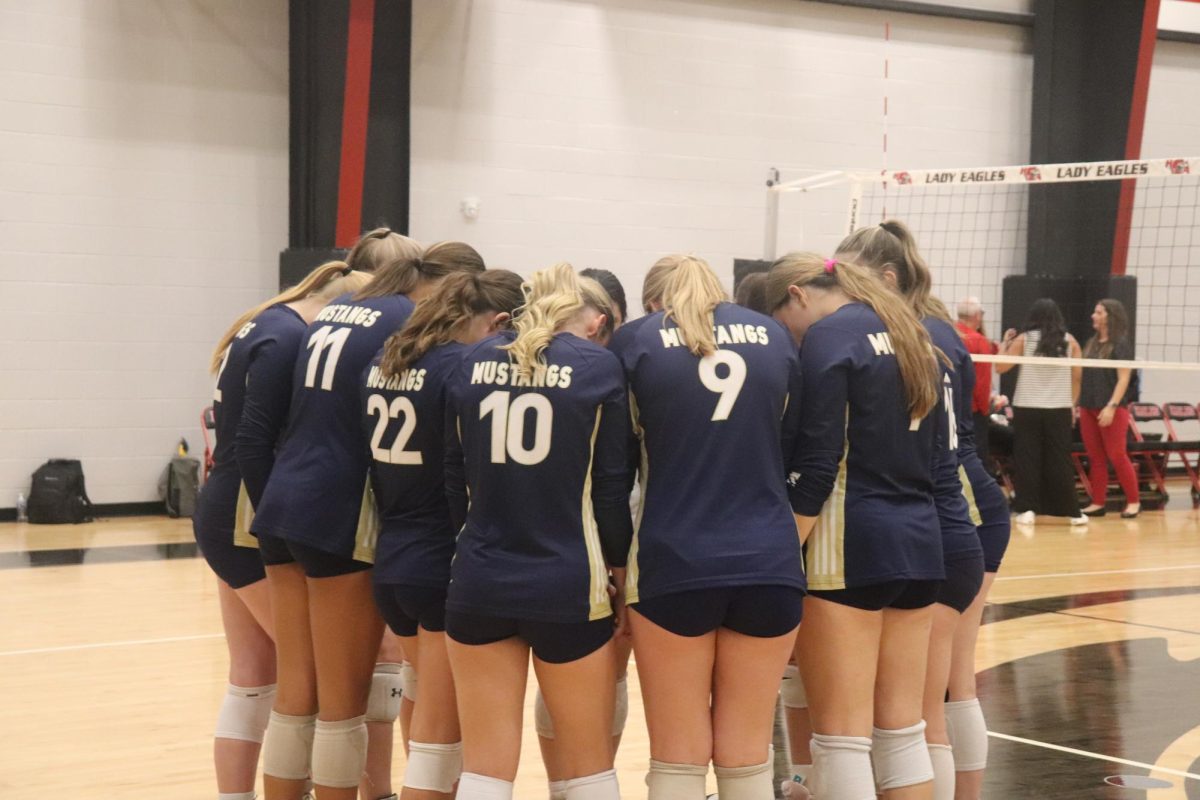 The Lady Mustangs pray before the game.