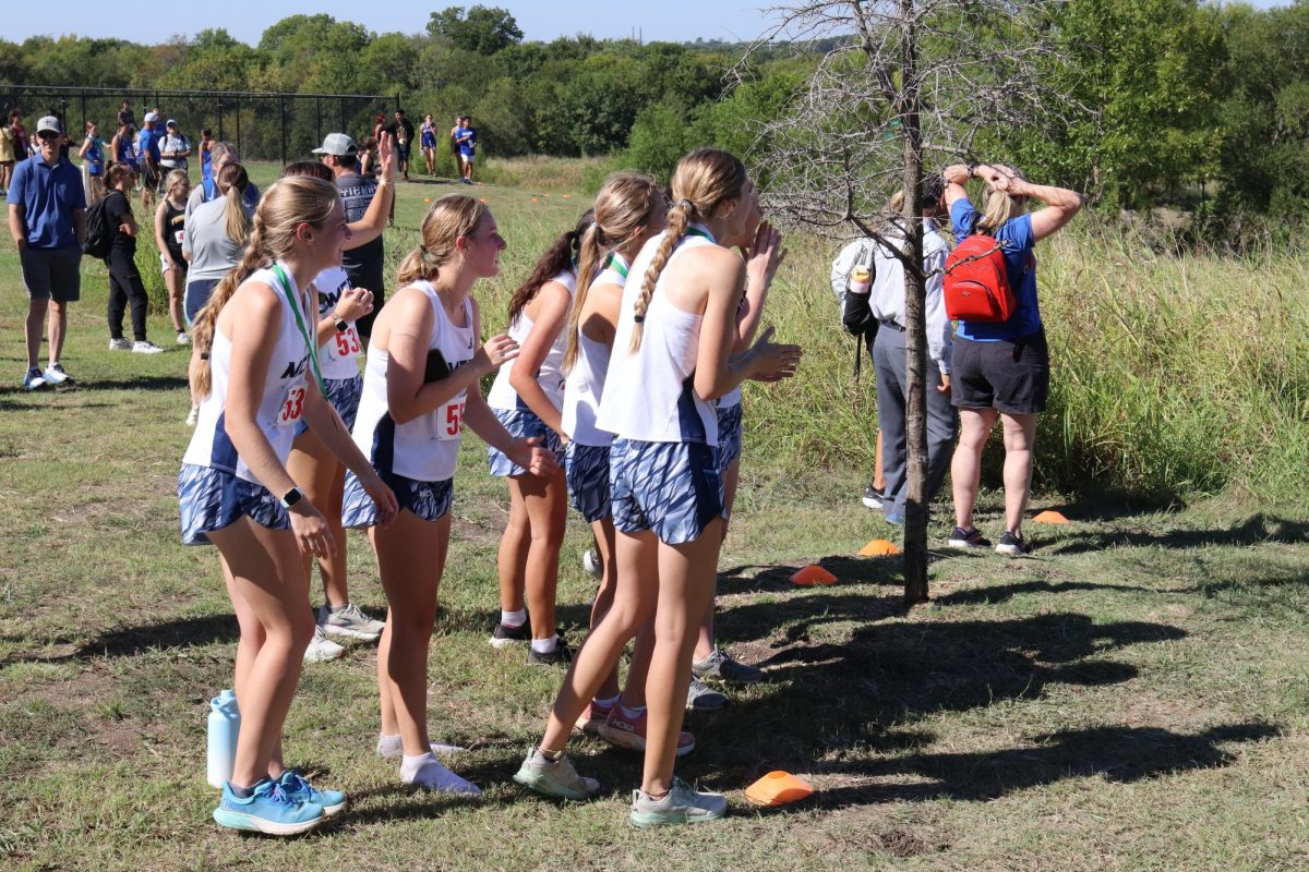 The cross country girls cheer on the runners. 