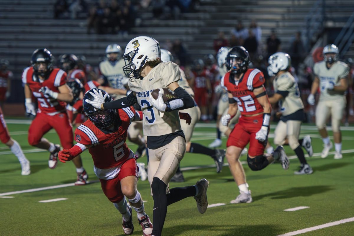 Sophomore Harry Thompson runs past the defender.