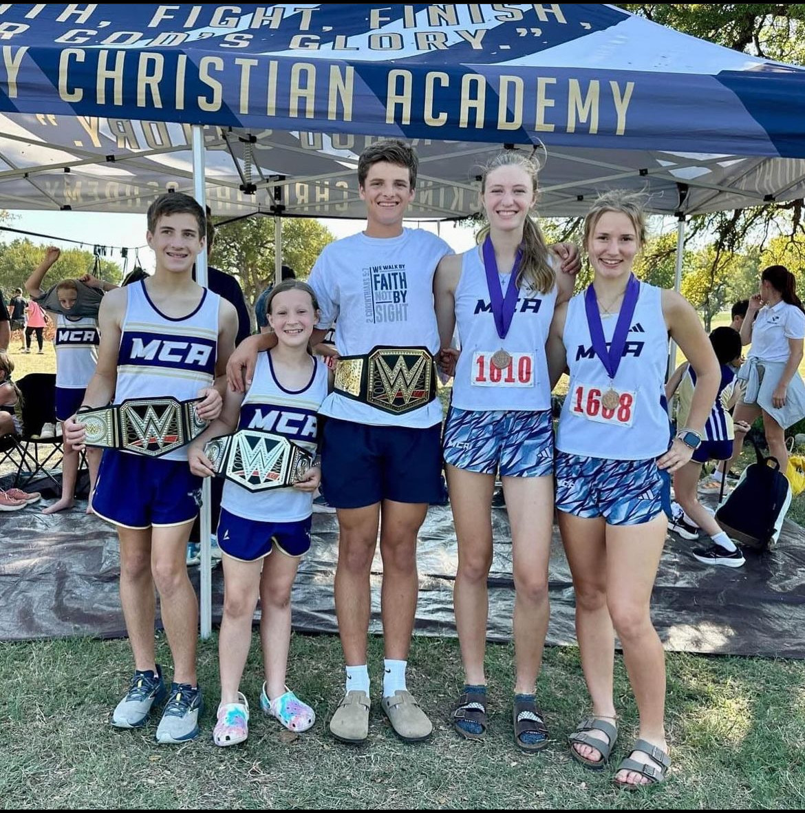 The Upper and Middle School runners take a picture with their awards.