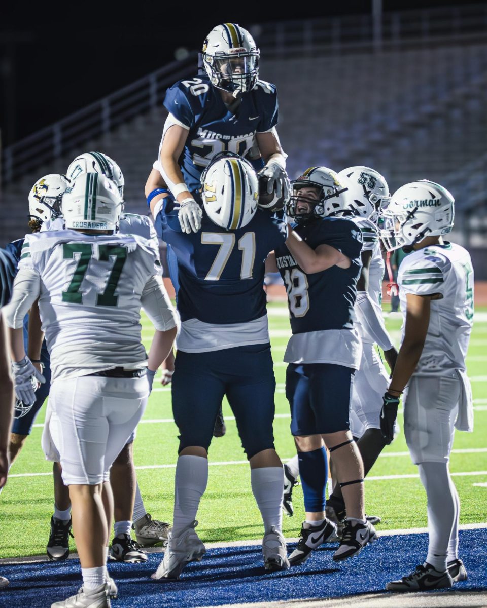 The team celebrates senior Evan Beecker's touchdown. 