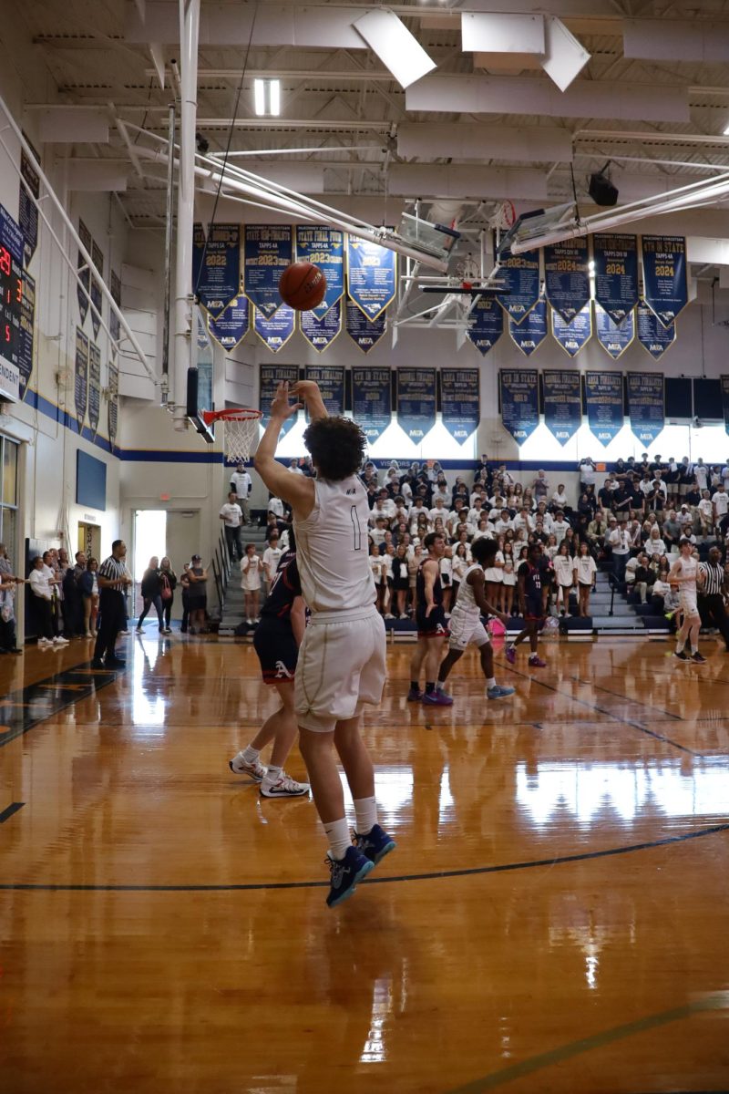 Senior Jace Scott shoots a three-pointer.