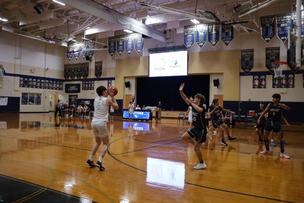 Senior Drew Hamilton shoots a three-pointer.