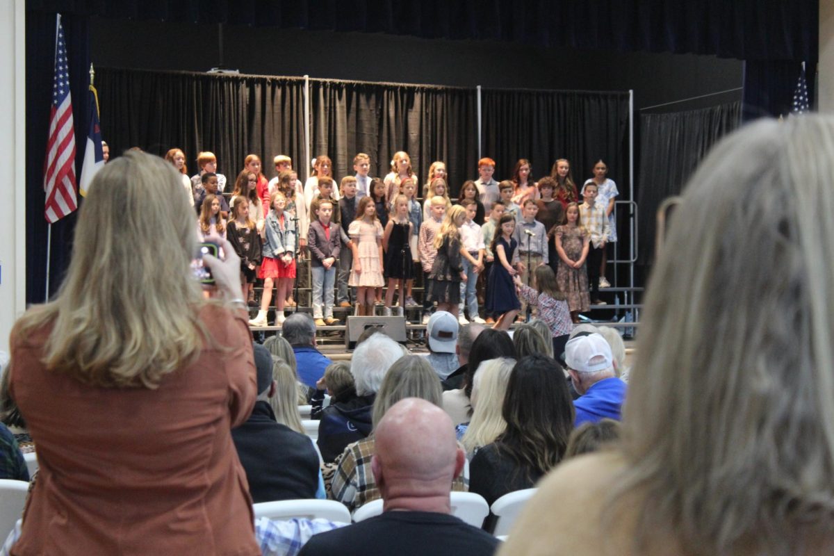 Students sing songs for grandparents.