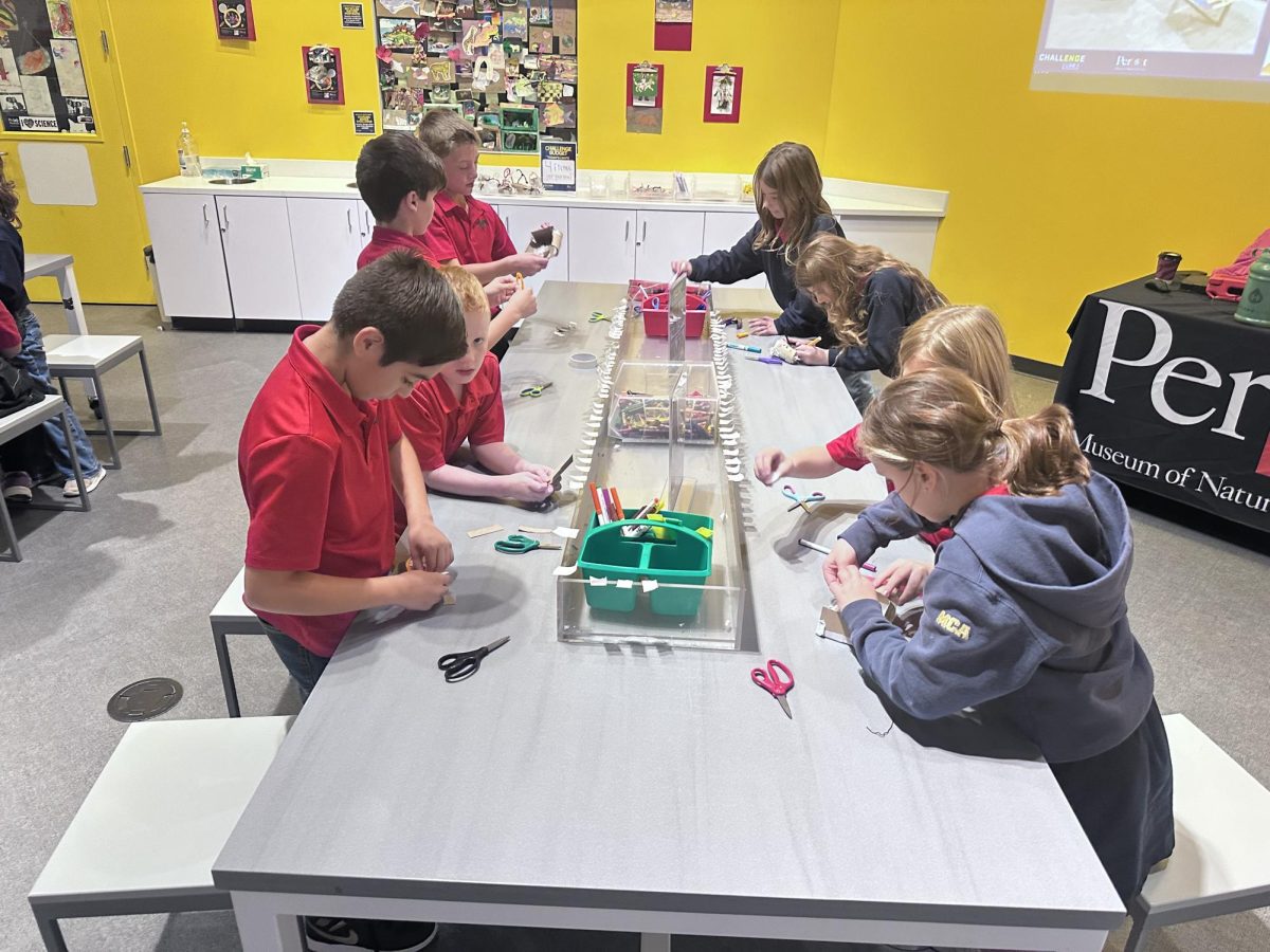 Students learn hands on at play table.