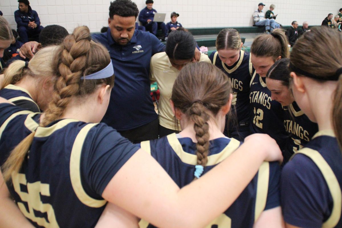 Lady Mustangs huddle up before the game.