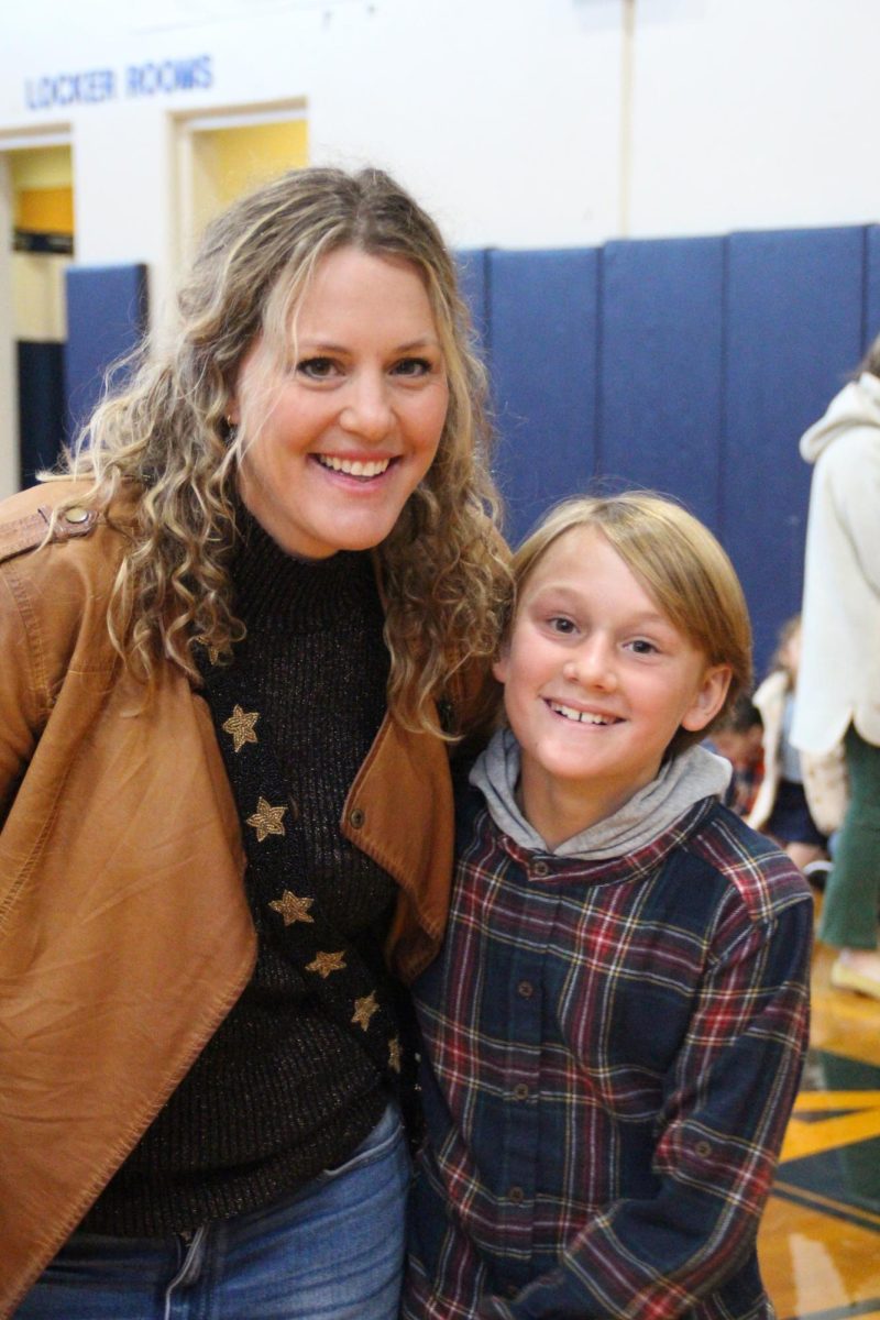 Mom and son take photo together.