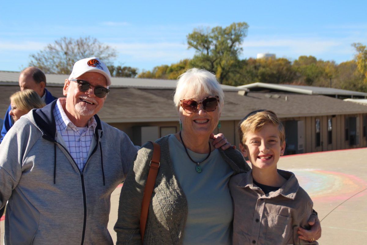 Lower School students takes picture with grandparents.